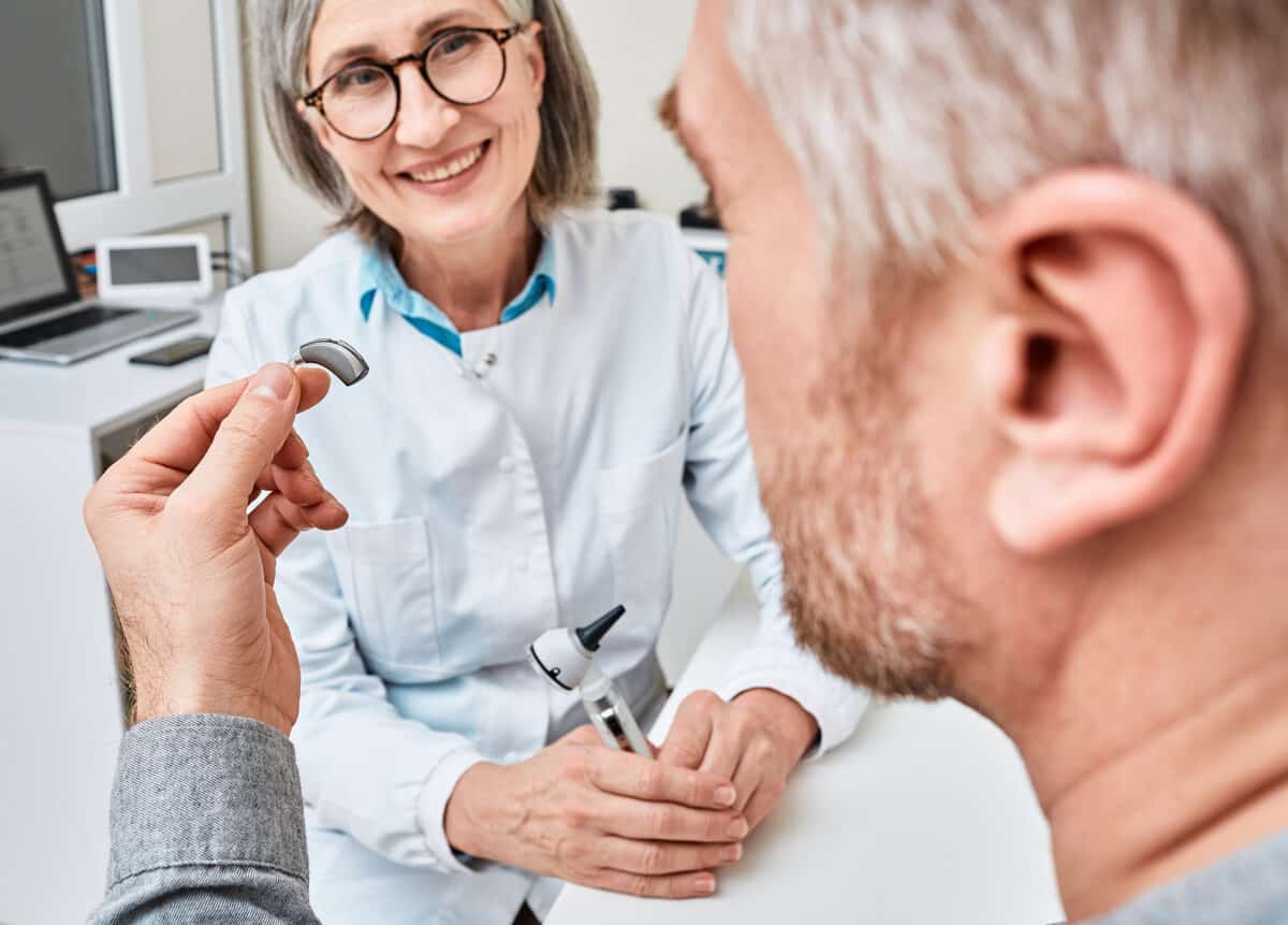 Audiologist Discusses Hearing Aids With Man